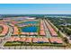 Panoramic aerial view showcasing the community's layout, homes, and serene lake setting at 17578 Holly Well Ave, Wimauma, FL 33598