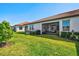Well-maintained backyard with a screened-in patio, perfect for relaxing and entertaining guests at 17578 Holly Well Ave, Wimauma, FL 33598