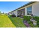Spacious backyard featuring a screened patio, lush lawn, and manicured landscaping at 17578 Holly Well Ave, Wimauma, FL 33598