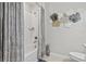 Bright bathroom with a tub-shower combo and contemporary decorative accents at 17578 Holly Well Ave, Wimauma, FL 33598
