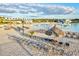 Relax on the community's white sand beach with beach umbrellas, lounge chairs, and a large lagoon at 17578 Holly Well Ave, Wimauma, FL 33598