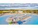 Picturesque beach area featuring rows of lounge chairs, umbrellas, and kayaks, offering relaxation and water activities at 17578 Holly Well Ave, Wimauma, FL 33598