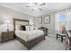Comfortable bedroom with a well-dressed bed, bedside tables, and soft lighting at 17578 Holly Well Ave, Wimauma, FL 33598