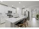Beautiful kitchen with white cabinets, stainless steel appliances, a large center island and barstool seating at 17578 Holly Well Ave, Wimauma, FL 33598