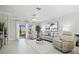 Bright living room with access to an outdoor patio, perfect for entertaining at 17578 Holly Well Ave, Wimauma, FL 33598