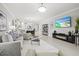 Comfortable living room with a large TV, fireplace, and stylish furnishings at 17578 Holly Well Ave, Wimauma, FL 33598