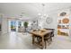 Open concept living room and dining area with stylish furniture and decor at 17578 Holly Well Ave, Wimauma, FL 33598