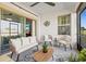 Relaxing outdoor patio featuring comfortable seating, a ceiling fan, and bright light at 17578 Holly Well Ave, Wimauma, FL 33598