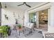 Charming patio with comfortable seating, stylish decor, and outdoor ambiance at 17578 Holly Well Ave, Wimauma, FL 33598