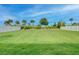 Large, well-maintained backyard with lush green grass, landscaping, and white fencing at 17732 Wayside Bnd, Punta Gorda, FL 33982