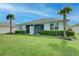 Exterior view of home featuring the backyard with patio and palm trees at 17732 Wayside Bnd, Punta Gorda, FL 33982