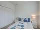 Comfortable bedroom featuring a white bed frame, stylish blue floral bedding, and a closet at 17732 Wayside Bnd, Punta Gorda, FL 33982