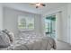 Comfortable bedroom featuring a sliding glass door to the screened lanai at 17732 Wayside Bnd, Punta Gorda, FL 33982