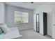 Sunlit bedroom with large window, and wardrobe with mirrors at 17732 Wayside Bnd, Punta Gorda, FL 33982