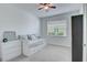 Bright bedroom featuring a twin daybed, dresser, ceiling fan and a view from the window at 17732 Wayside Bnd, Punta Gorda, FL 33982
