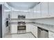 Modern kitchen featuring stainless steel appliances, granite countertops and white cabinetry at 17732 Wayside Bnd, Punta Gorda, FL 33982