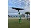 Community park with a modern solar powered charging table and lush greenery with a lake view at 17732 Wayside Bnd, Punta Gorda, FL 33982