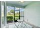 Relaxing screened patio area with a table, chairs, and views of the backyard at 17732 Wayside Bnd, Punta Gorda, FL 33982