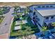 Aerial view of a playground area with sunshades and a building with outdoor stairs at 17732 Wayside Bnd, Punta Gorda, FL 33982