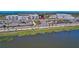 View of commercial buildings along the road and landscaping near the lake at 17732 Wayside Bnd, Punta Gorda, FL 33982