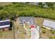 Aerial view of a single Gathering home in a suburban neighborhood with mature trees and sunny skies at 1821 16Th E Ave, Bradenton, FL 34208
