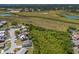Aerial view of a single Gathering home in a suburban neighborhood with mature trees and sunny skies at 1821 16Th E Ave, Bradenton, FL 34208