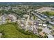 An aerial view showcases homes in a community near green spaces, promoting a serene environment at 1821 16Th E Ave, Bradenton, FL 34208