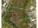 Large land plot with defined property lines, surrounded by trees and some residential housing at 1821 16Th E Ave, Bradenton, FL 34208