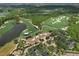 Overhead view of the golf course, which features beautiful fairways, manicured greens, and a clubhouse, surrounded by trees at 18826 Ganton Ave, Lakewood Ranch, FL 34202
