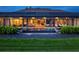A luxurious backyard with a pool, covered patio, fire pits, and an outdoor seating area for entertaining guests at 18826 Ganton Ave, Lakewood Ranch, FL 34202