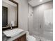 Bathroom featuring a glass-enclosed shower, subway tile, mosaic floor, and modern sink with granite countertop at 18826 Ganton Ave, Lakewood Ranch, FL 34202