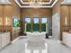 This large bathroom has a soaking tub, a chandelier, a big window, and granite countertops at 18826 Ganton Ave, Lakewood Ranch, FL 34202