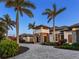 A beautiful, luxury, single-Gathering home with an elegant portico, a circular driveway, and professionally manicured landscaping at 18826 Ganton Ave, Lakewood Ranch, FL 34202