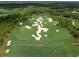 Scenic aerial shot of the lush golf course with intricate sand traps and pristine green fairways on a sunny day at 18826 Ganton Ave, Lakewood Ranch, FL 34202