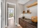 Hallway view with decorative shelving and an open view into a bright sitting room at 18826 Ganton Ave, Lakewood Ranch, FL 34202
