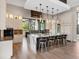 Gourmet kitchen with an expansive island, seating, modern pendants, and luxury finishes at 18826 Ganton Ave, Lakewood Ranch, FL 34202