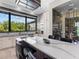 Modern kitchen with an island cooktop, wine rack, and a view of the backyard at 18826 Ganton Ave, Lakewood Ranch, FL 34202