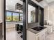 Modern kitchen with an island cooktop, wine rack, and large window at 18826 Ganton Ave, Lakewood Ranch, FL 34202