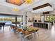 Gourmet kitchen with waterfall island, stainless steel appliances, and adjacent dining area overlooking the lake at 18826 Ganton Ave, Lakewood Ranch, FL 34202
