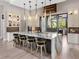 Modern kitchen with marble island, designer lighting, and stainless steel appliances at 18826 Ganton Ave, Lakewood Ranch, FL 34202