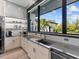 Kitchen area featuring granite counters, stainless appliances, and view of exterior at 18826 Ganton Ave, Lakewood Ranch, FL 34202