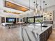 Luxury kitchen with an oversized island, marble countertops, stainless steel sink, and open concept living space at 18826 Ganton Ave, Lakewood Ranch, FL 34202