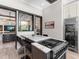Modern kitchen with an island cooktop, wine cooler, and seating at 18826 Ganton Ave, Lakewood Ranch, FL 34202