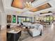 Spacious living room with modern furnishings and elegant lighting, opening to outdoor living space at 18826 Ganton Ave, Lakewood Ranch, FL 34202