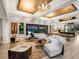Open-concept living room featuring stylish decor, abundant natural light, and serene lake views at 18826 Ganton Ave, Lakewood Ranch, FL 34202