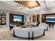 Inviting living room with a large sectional sofa, entertainment center, and seamless access to outdoor spaces at 18826 Ganton Ave, Lakewood Ranch, FL 34202