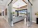 Open-concept living room showcasing a modern chandelier and sliding glass doors with water views at 18826 Ganton Ave, Lakewood Ranch, FL 34202
