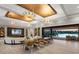 Open concept living space with modern lighting fixtures, large dining table, and scenic waterfront view at 18826 Ganton Ave, Lakewood Ranch, FL 34202