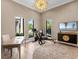 An airy office has a Peloton exercise bike, a desk with a chair, and a modern television at 18826 Ganton Ave, Lakewood Ranch, FL 34202