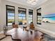 Modern office space featuring a unique wood desk and large windows with beautiful water views at 18826 Ganton Ave, Lakewood Ranch, FL 34202